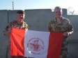 Mike presents a flag from Hemel FC U10s to the Brigade Commander in Afghanistan