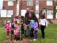 Mike Penning, helped by local children, plants a tree at Nash Green in Nash Mills in honour of the Queen’s Diamond Jubilee